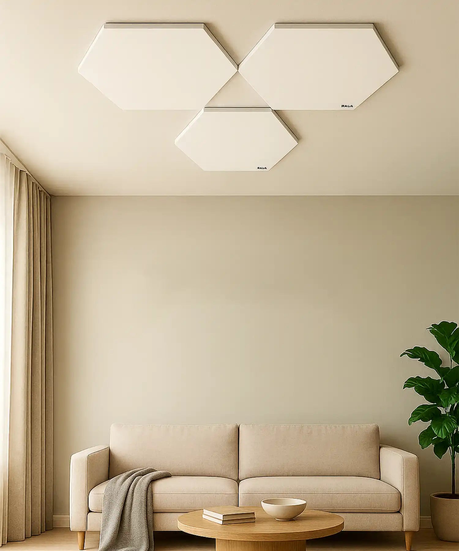 Minimalist living room with beige sofa and three white hexagonal infrared panels mounted flat against the ceiling.