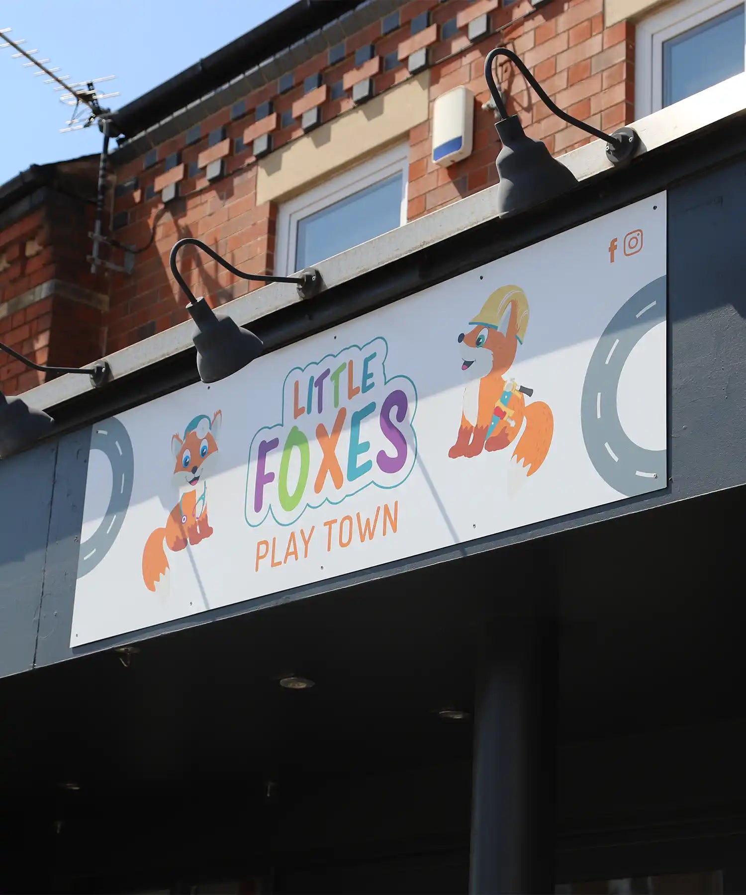 Exterior signage of Little Foxes Play Town featuring cartoon fox characters and playful branding above the entrance.