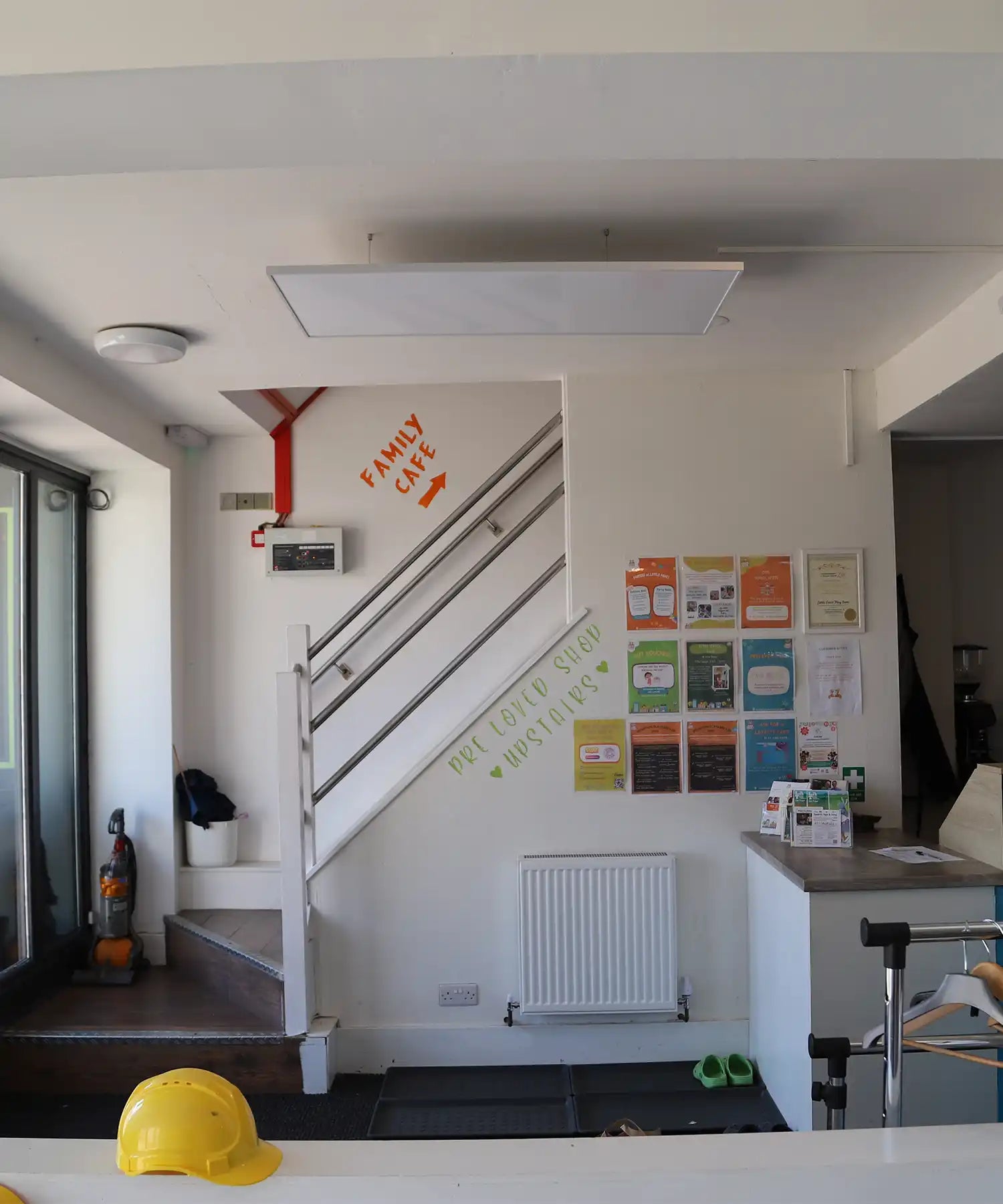 Reception area and stairwell inside Little Foxes Play Town, with an infrared heating panel suspended from the ceiling for efficient warmth.