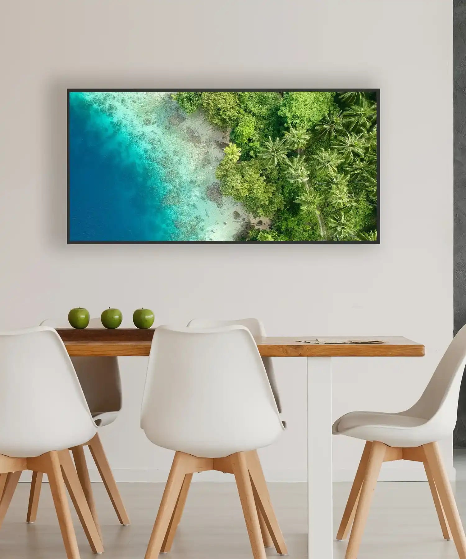 Modern dining area with a bird’s eye view infrared picture panel showing a tropical beach and lush forest, blending art and heating