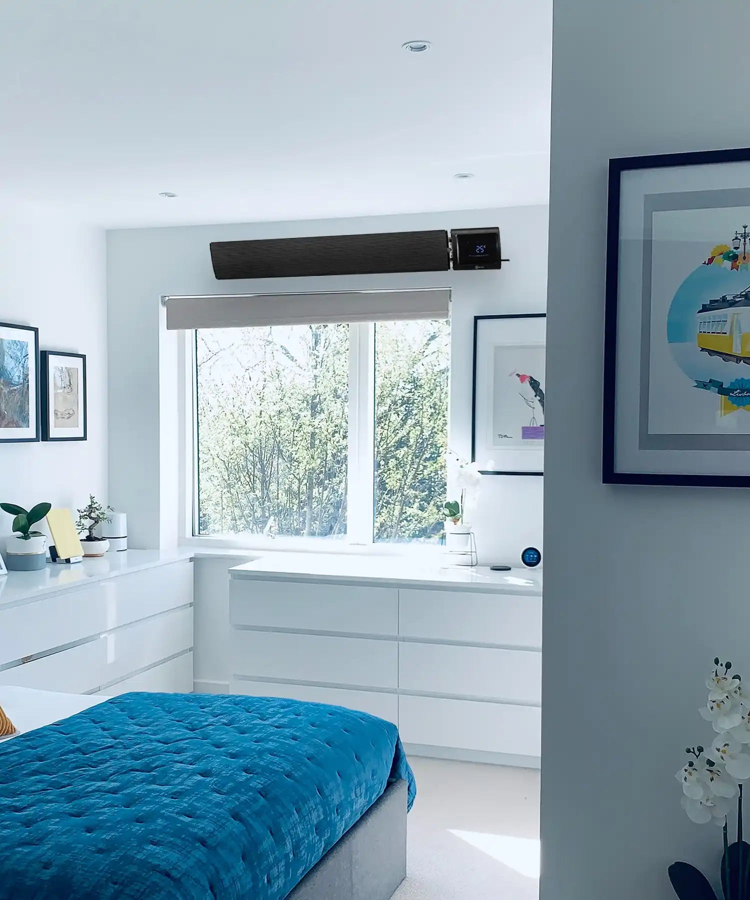 Black KIASA infrared heater bar wall mounted above a window in a traditional white kitchen with wooden accents.