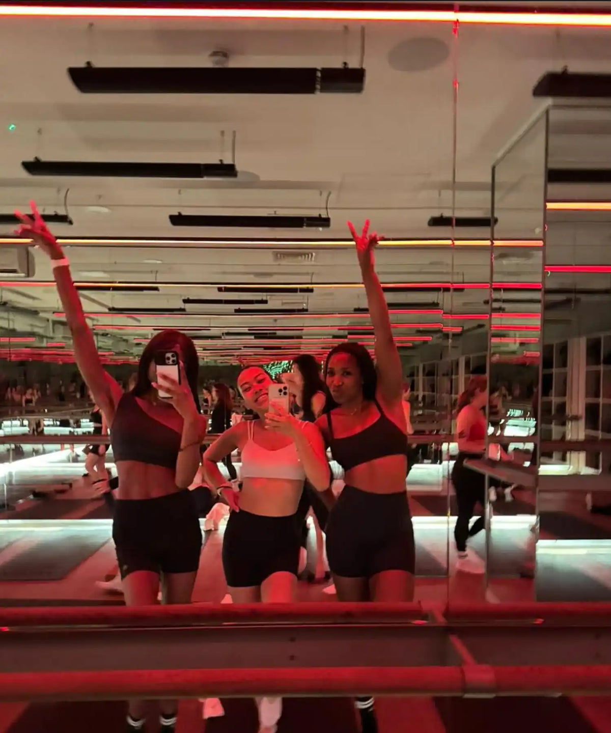 Professional barre studio using ceiling-mounted KIASA IKON infrared heater bars to deliver consistent radiant heat during strength and conditioning workouts.