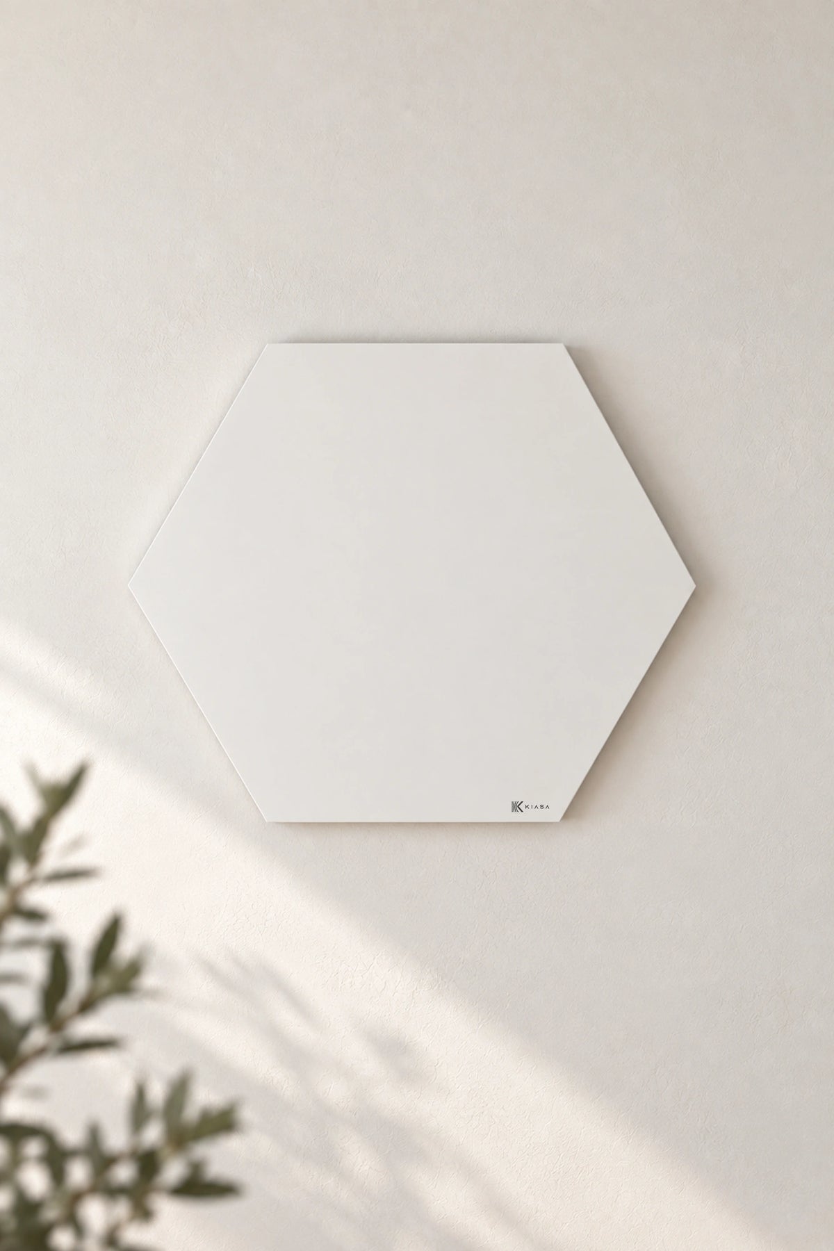 Four KIASA hexagon infrared heating panels in a honeycomb arrangement on a living room wall above a sofa