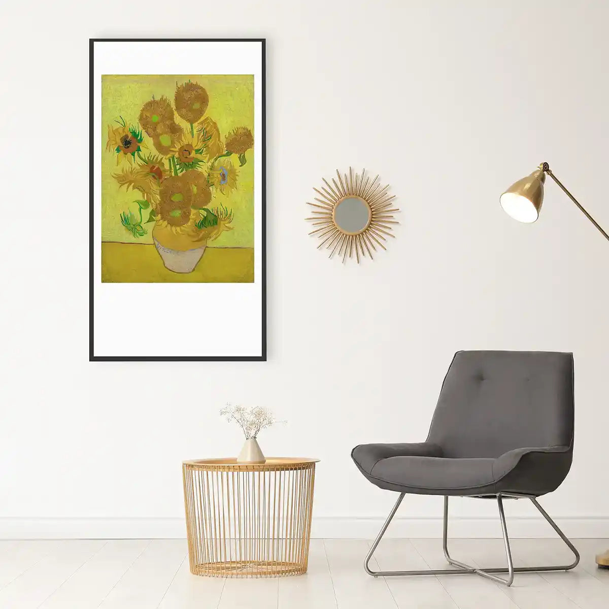 Van Gogh sunflower print infrared picture heater mounted on a living room wall next to a gold floor lamp, grey armchair, and decorative mirror.