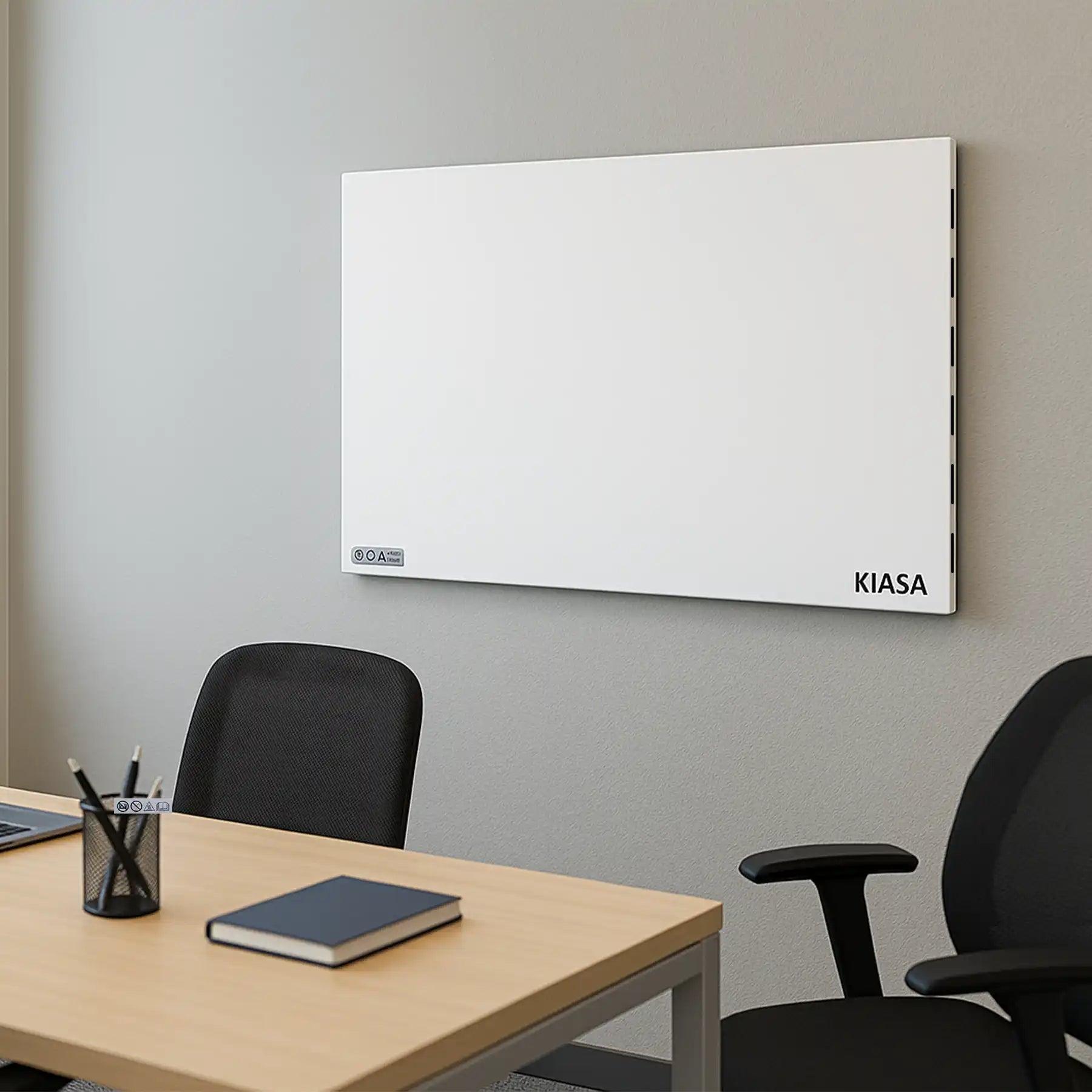 Kiasa Kore Hybrid Heater wall-mounted in a contemporary office with large windows and a laptop on desk
