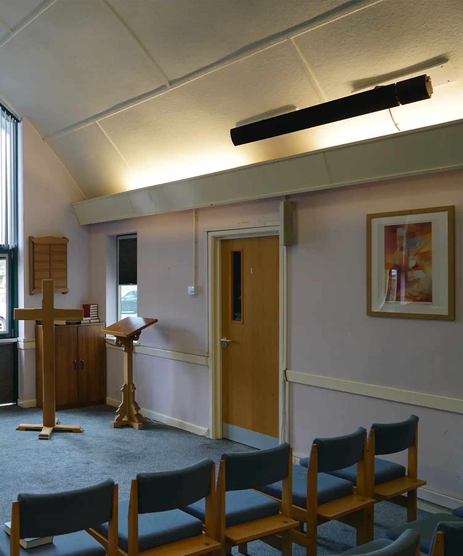 Infrared heater mounted on exterior wall delivering targeted warmth for outdoor seating area