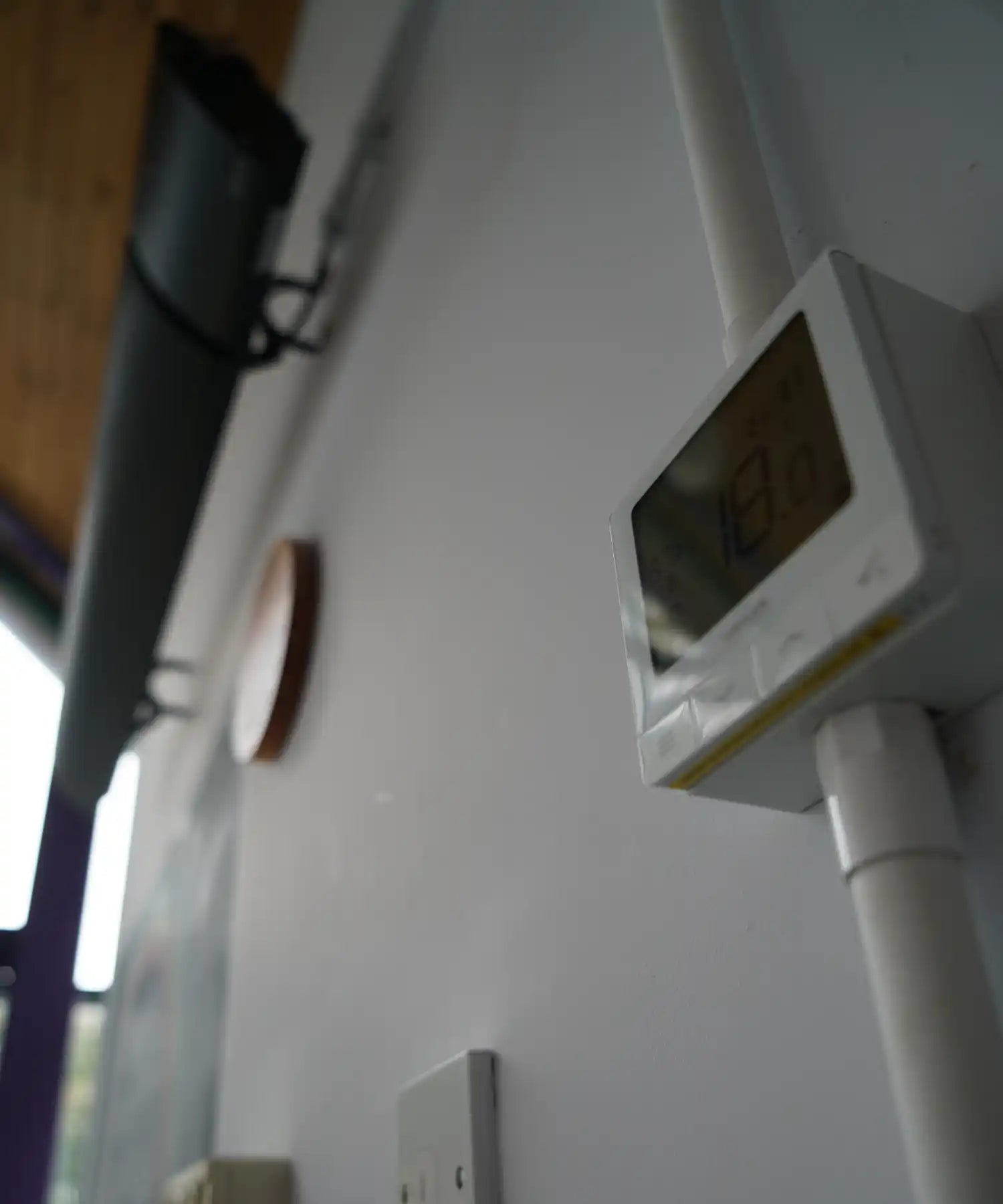 Wall-mounted Raydr Road infrared heater providing radiant warmth for outdoor seating areas