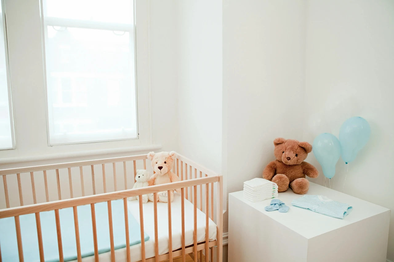 A baby pram and a teddy bear in a room