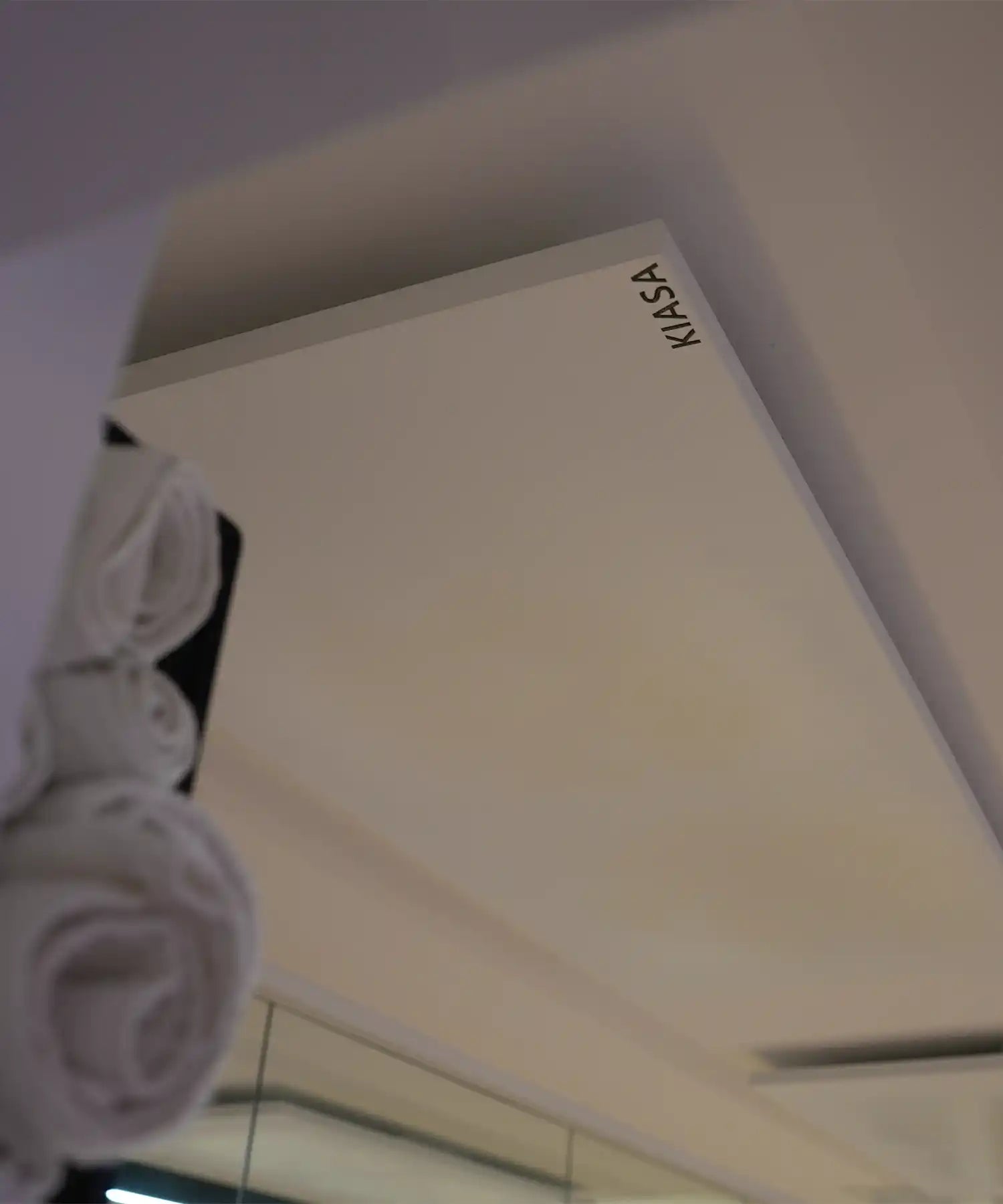 Close-up of a ceiling-mounted KIASA infrared heating panel installed flush within a modern studio ceiling for discreet radiant heating.