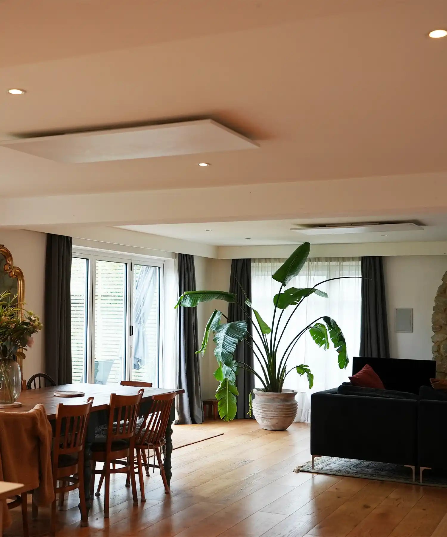 Open-plan living and dining area at Denmark House with ceiling-mounted infrared heating for residential music retreats