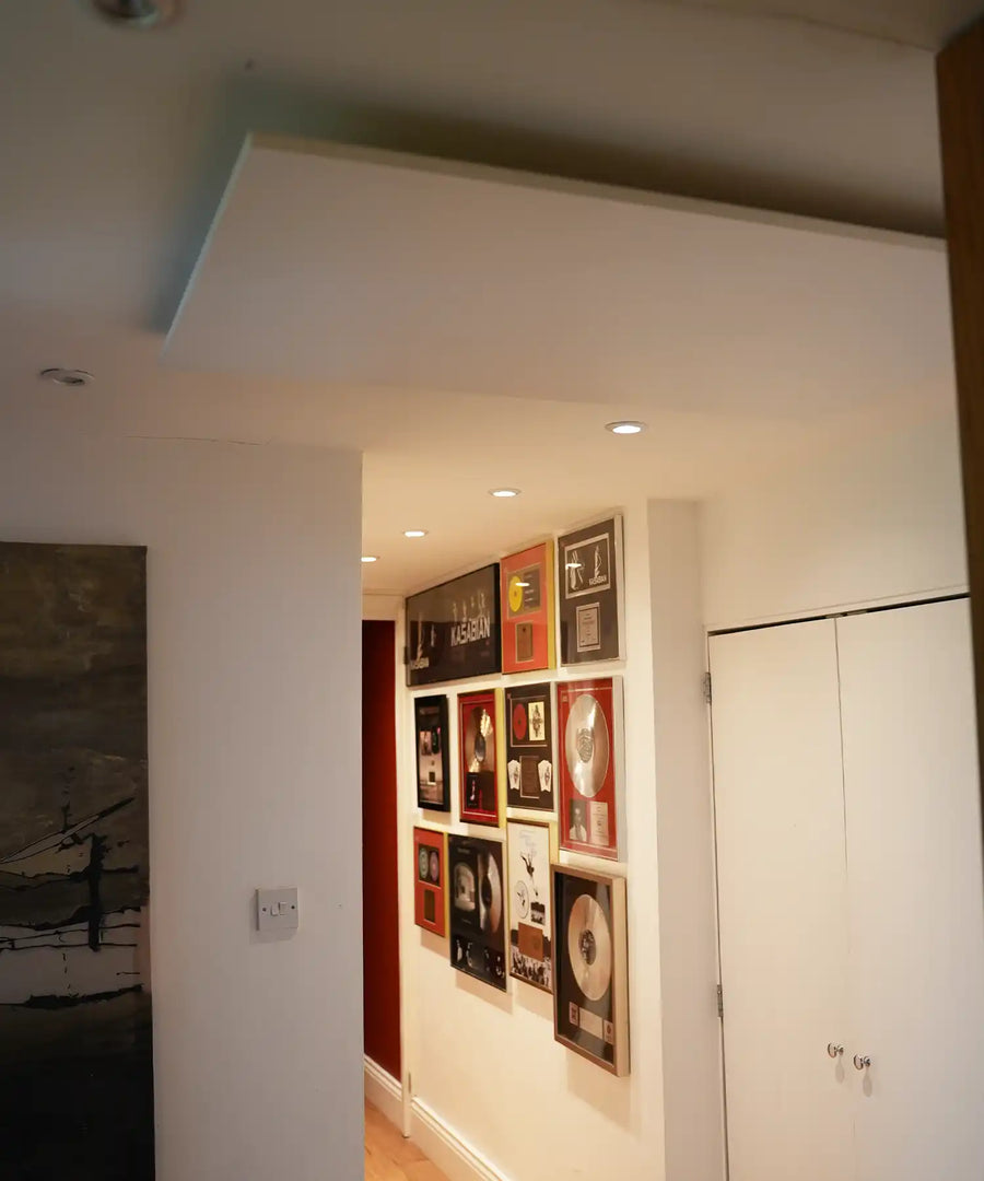 Hallway at Bluebell Hill Studios displaying framed music awards with ceiling-mounted infrared heating panels above
