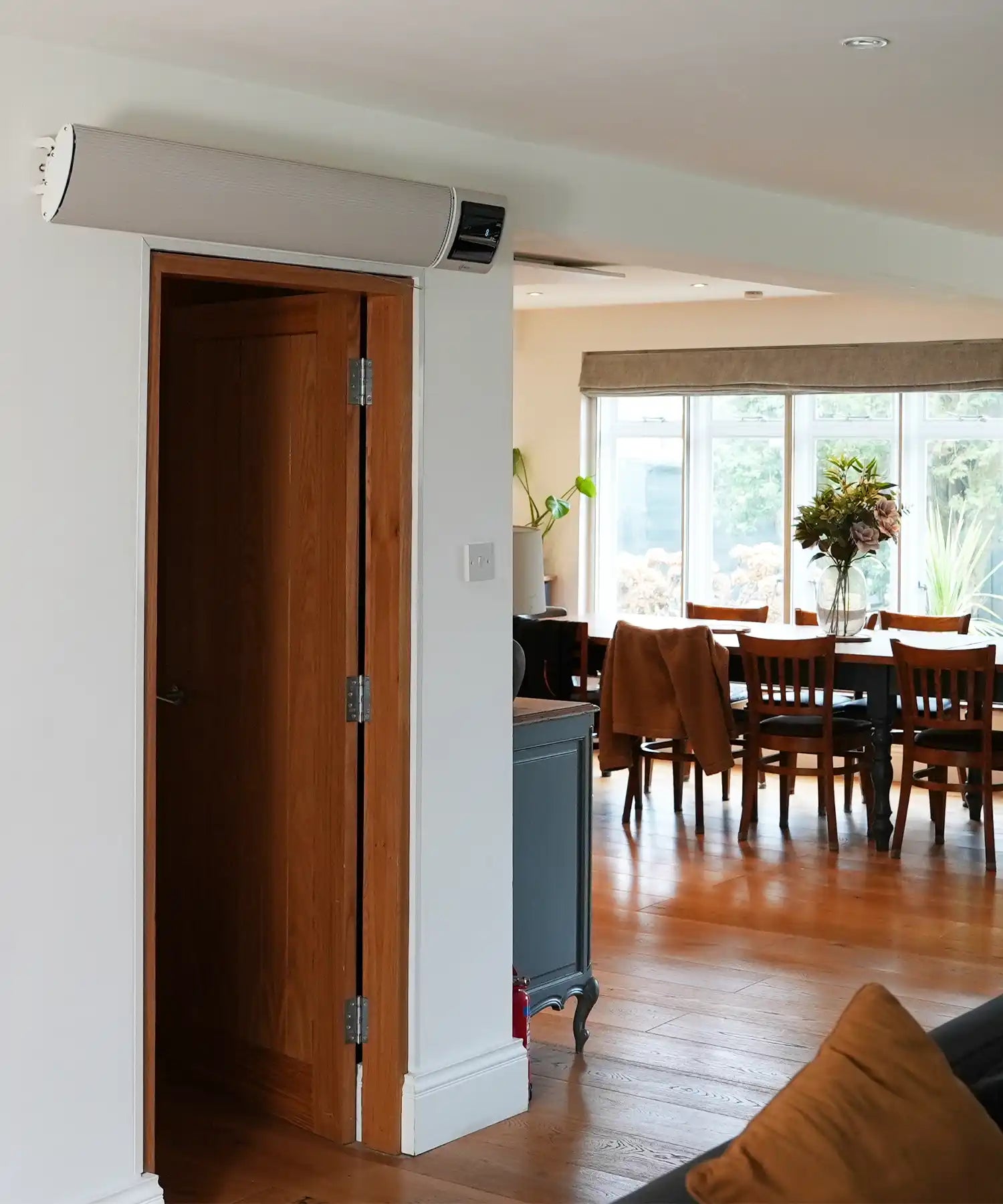 Wall-mounted infrared heater bar providing silent, energy-efficient heating in a residential studio space