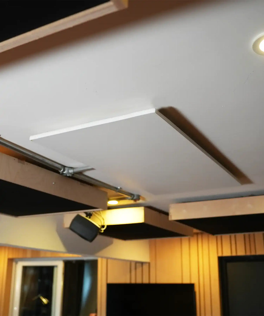 Ceiling-mounted infrared heating panel installed in a recording studio for silent, energy-efficient warmth
