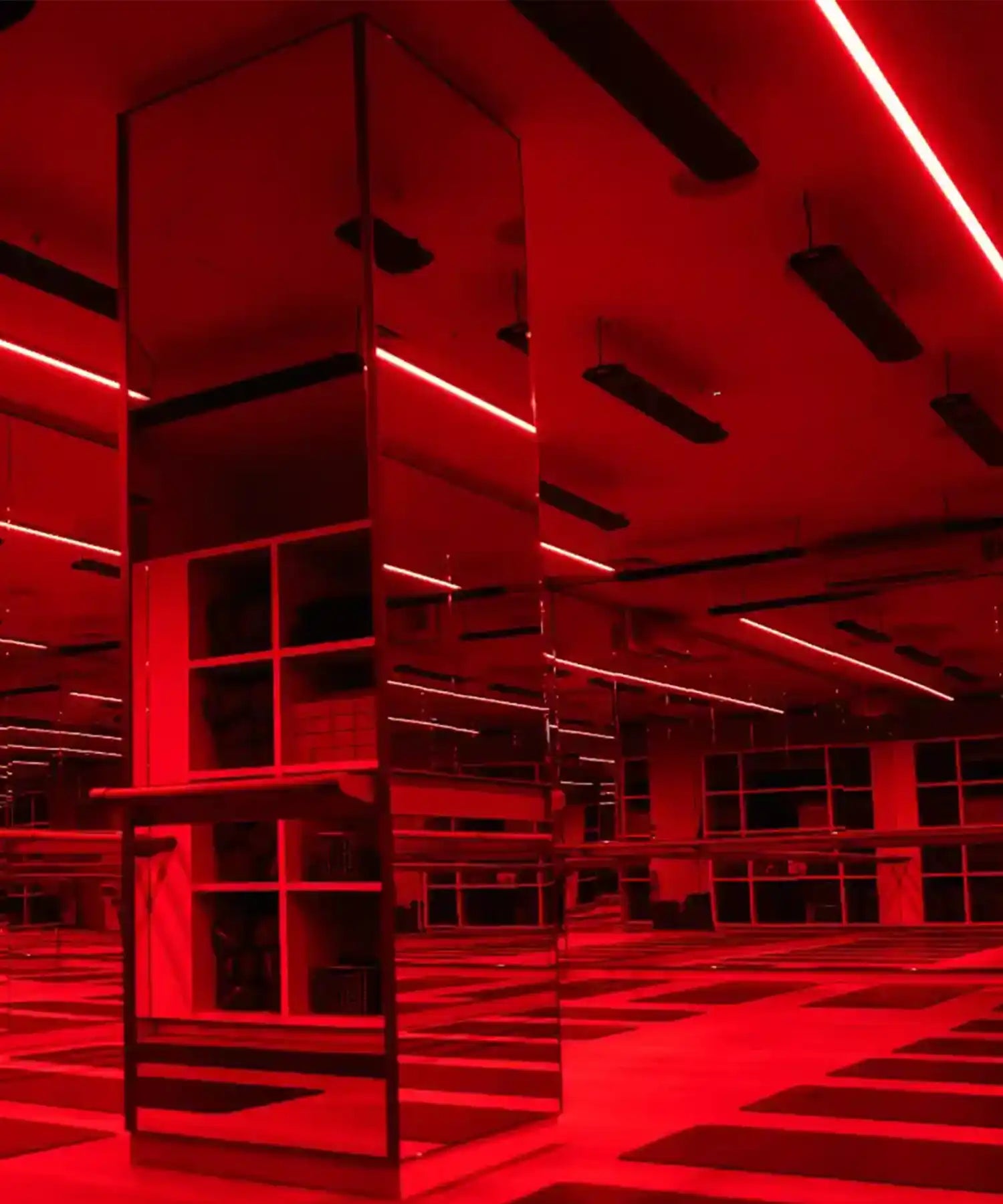 Red-lit interior of a modern building with geometric architecture