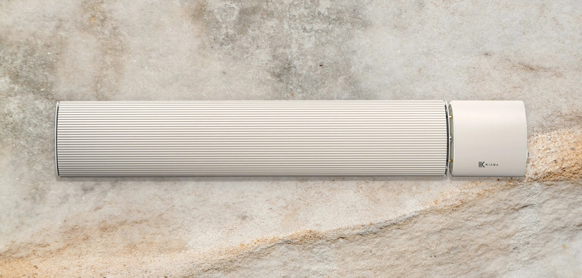 IKON Heritage infrared heater bar in soft beige on a pale historic stone wall