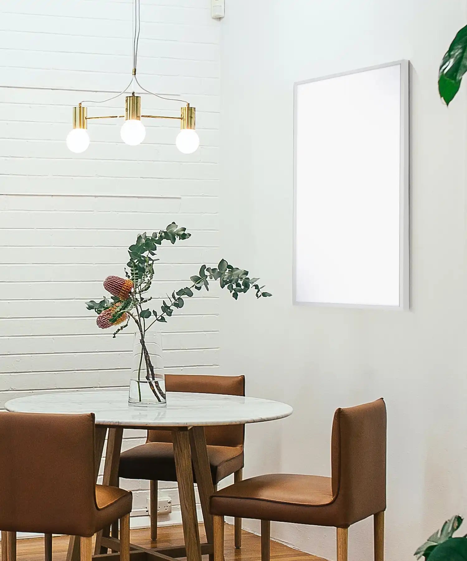 Modern dining room with wall mounted infrared heating panel providing radiant warmth.