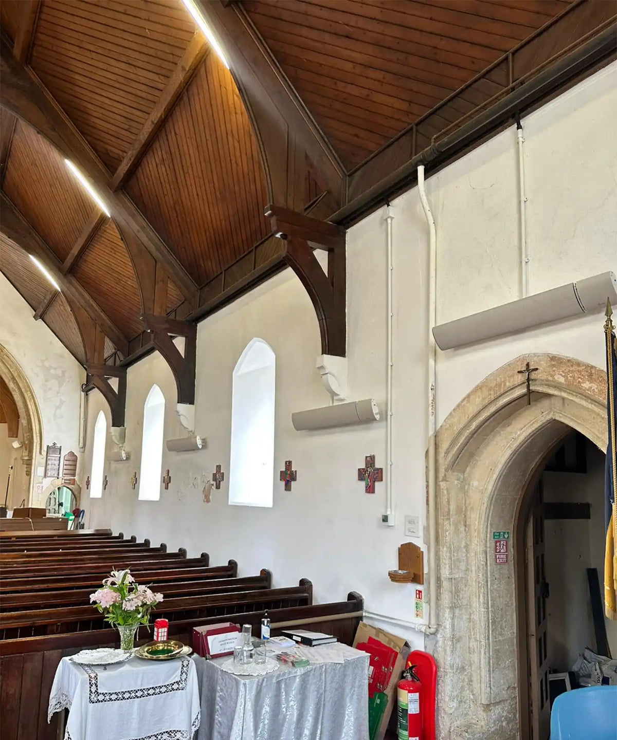 Multiple IKON beige infrared heating panels illuminating church space by Kiasa Heating