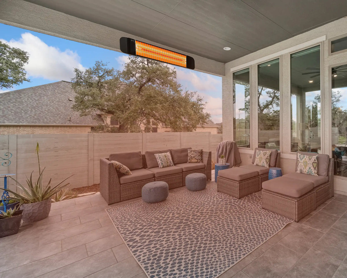 KIASA Sona outdoor infrared heater mounted on a covered patio ceiling above garden seating